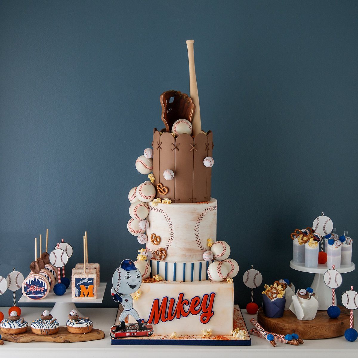 Baseball themed cake and dessert table with baseball decorations and snacks
