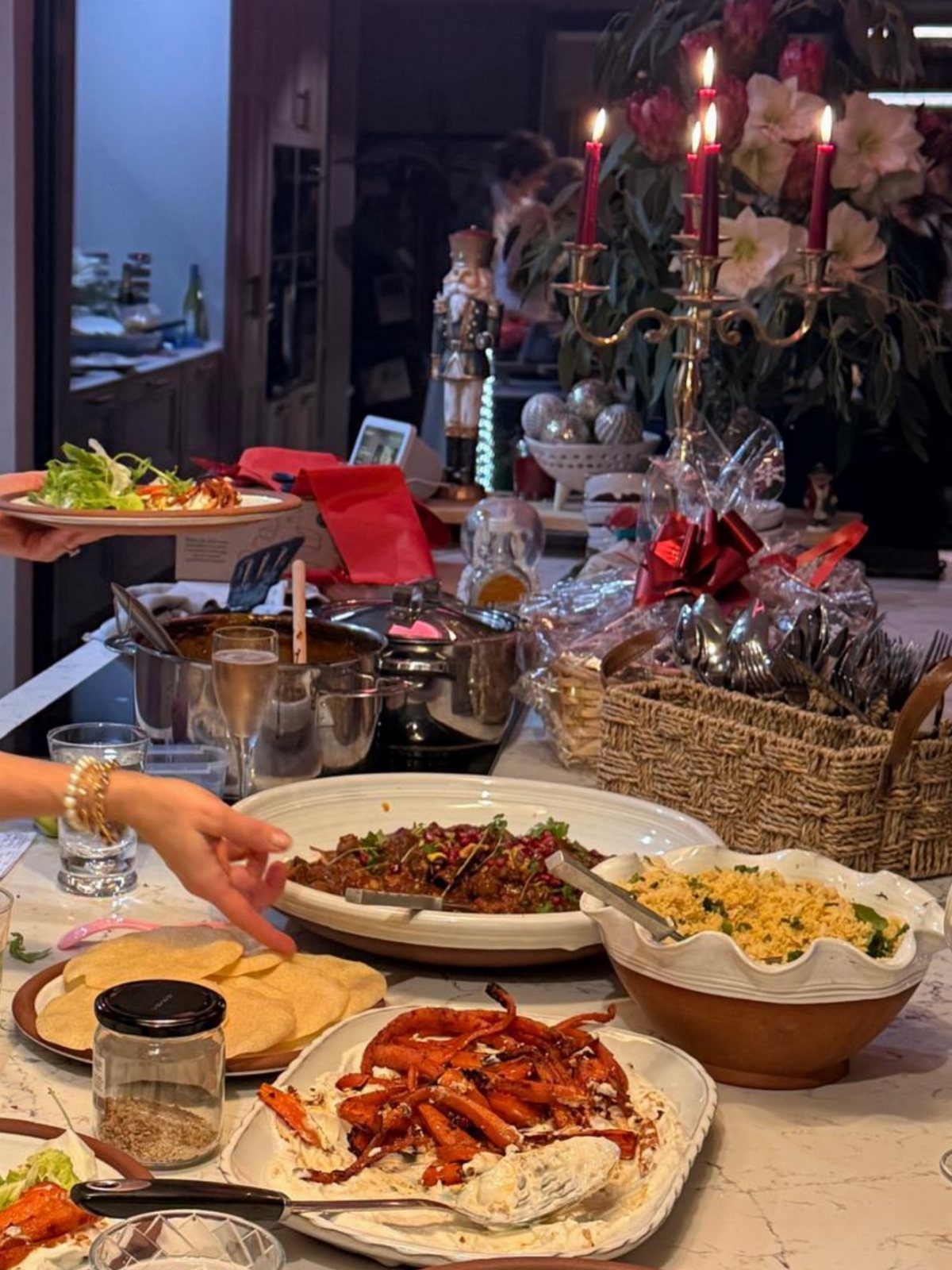 Dinner party spread with octopus, tacos, and rice on a white table.