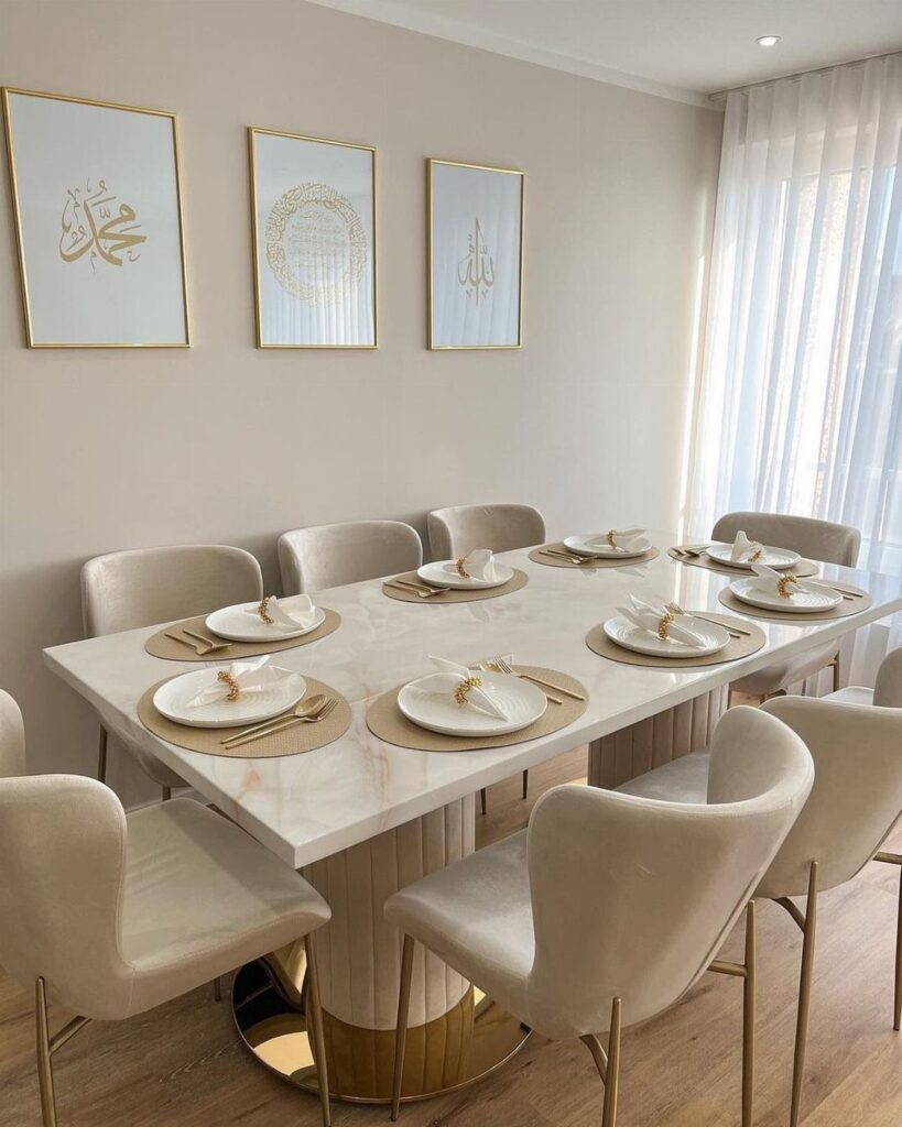 Marble dining table set with gold accents and beige chairs in a modern room.
